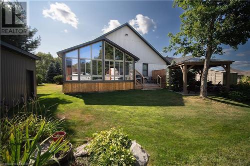 Rear view of property with a gazebo, a yard, a shed, and a sunroom - 748 Coursol Road, Sturgeon Falls, ON - Outdoor With Deck Patio Veranda