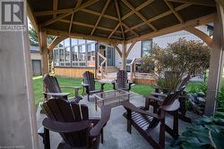 View of patio featuring a gazebo, a sunroom, and an outdoor living space - 