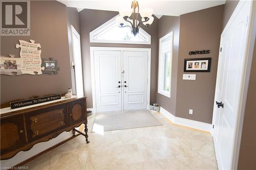 Foyer entrance featuring light tile patterned flooring and a chandelier - 748 Coursol Road, Sturgeon Falls, ON - Indoor Photo Showing Other Room