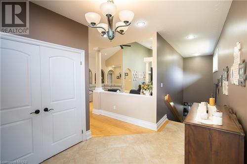 Bathroom with hardwood / wood-style flooring, vaulted ceiling, a notable chandelier, and ornate columns - 748 Coursol Road, Sturgeon Falls, ON - Indoor Photo Showing Other Room