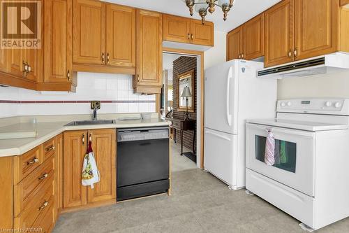 Kitchen featuring backsplash, sink, and white appliances - 133 Fairview Crescent, Woodstock, ON - Indoor Photo Showing Kitchen