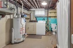 Laundry area featuring water heater and washer and dryer - 