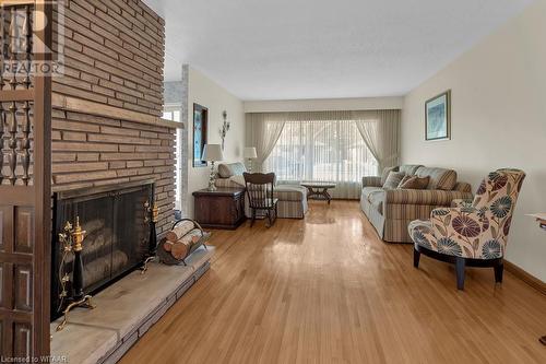 Living room featuring light wood-type flooring and a fireplace - 133 Fairview Crescent, Woodstock, ON - Indoor Photo Showing Living Room With Fireplace