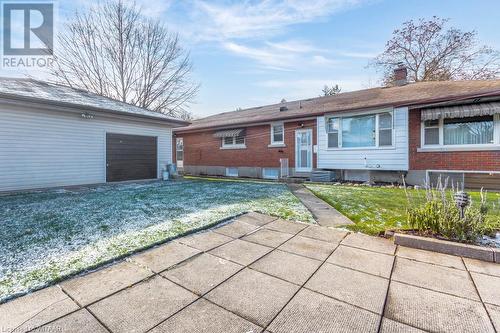 Back of property with a yard and a garage - 133 Fairview Crescent, Woodstock, ON - Outdoor