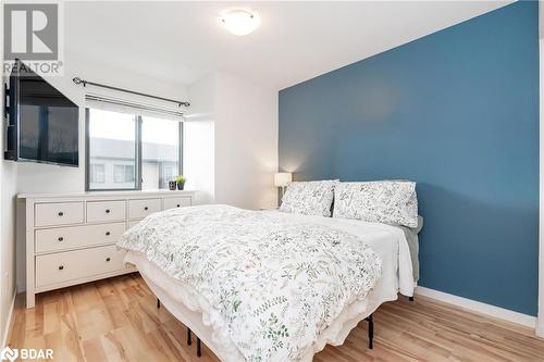 Bedroom with laminate floors, window, feature wall, and closet - 369 Essa Road Unit# 22, Barrie, ON - Indoor Photo Showing Bedroom