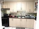 209 - 120 Dundalk Drive, Toronto, ON  - Indoor Photo Showing Kitchen With Double Sink 