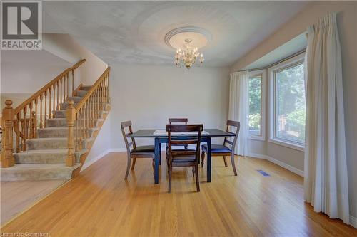 Dining space with hardwood / wood-style floors and a chandelier - 431 Northlake Drive, Waterloo, ON - Indoor