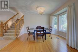 Dining space with hardwood / wood-style floors and a chandelier - 