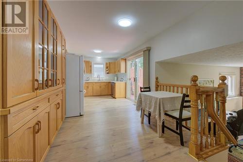 Kitchen with sink, light brown cabinets, stainless steel dishwasher, white refrigerator, and light hardwood / wood-style floors - 431 Northlake Drive, Waterloo, ON - Indoor Photo Showing Other Room