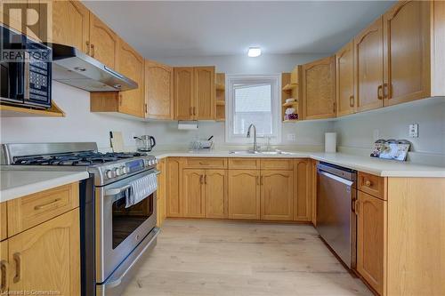 Kitchen with sink, light wood-type flooring, and appliances with stainless steel finishes - 431 Northlake Drive, Waterloo, ON - Indoor Photo Showing Kitchen With Double Sink