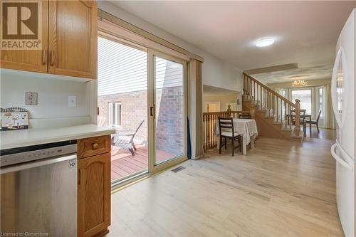 Kitchen with a chandelier, dishwasher, light hardwood / wood-style flooring, and white refrigerator - 431 Northlake Drive, Waterloo, ON - Indoor