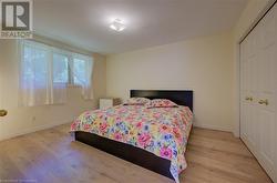 Bedroom with a closet and light hardwood / wood-style flooring - 