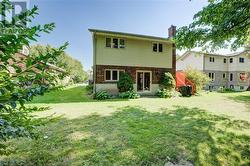 Rear view of house featuring a lawn - 