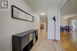 Corridor featuring light hardwood / wood-style flooring and a notable chandelier - 