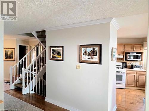 View from dining room wood-style floors, and a textured ceiling - 555 Main Street S Unit# 5, Callander, ON - Indoor