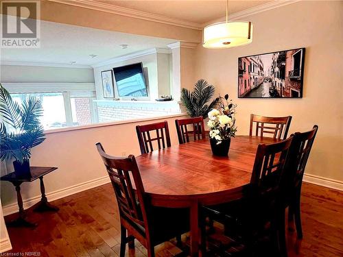 Dining space featuring crown molding and dark hardwood / wood-style floors - 555 Main Street S Unit# 5, Callander, ON - Indoor Photo Showing Dining Room