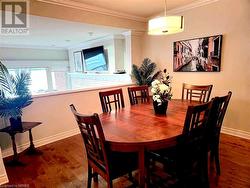 Dining space featuring crown molding and dark hardwood / wood-style floors - 