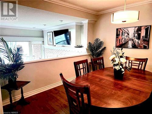 Dining room with a textured ceiling, wood-type flooring, and crown molding - 555 Main Street S Unit# 5, Callander, ON - Indoor Photo Showing Dining Room