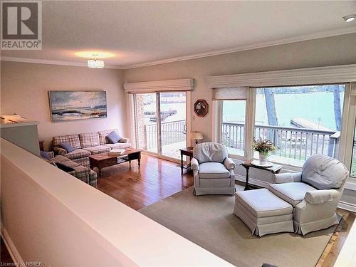 Sunkin Living room with wood-type flooring, a textured ceiling, and crown molding - 555 Main Street S Unit# 5, Callander, ON - Indoor Photo Showing Living Room