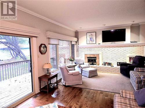 Sunkin Living room featuring a fireplace, hardwood / wood-style floors, plenty of natural light, and ornamental molding - 555 Main Street S Unit# 5, Callander, ON - Indoor Photo Showing Living Room With Fireplace