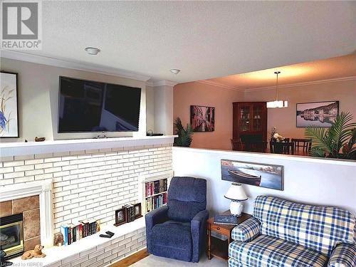 Sunkin Living room with a textured ceiling and crown molding - 555 Main Street S Unit# 5, Callander, ON - Indoor Photo Showing Living Room With Fireplace