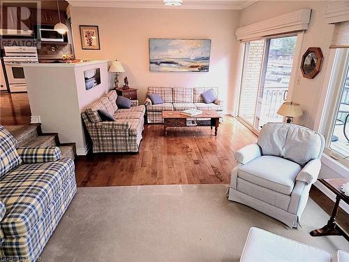 Sunkin Living room with hardwood / wood-style floors and ornamental molding - 555 Main Street S Unit# 5, Callander, ON - Indoor Photo Showing Living Room