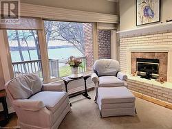 Living area featuring a gas fireplace, and a water view - 