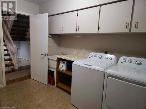 Laundry area featuring cabinets and utility sink - 555 Main Street S Unit# 5, Callander, ON - Indoor Photo Showing Laundry Room