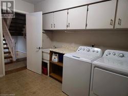 Laundry area featuring cabinets and utility sink - 