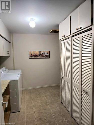 Main Floor laundryroom with tons of storage cabinets - 555 Main Street S Unit# 5, Callander, ON - Indoor Photo Showing Laundry Room