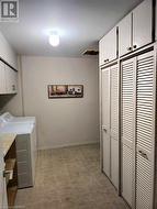 Main Floor laundryroom with tons of storage cabinets - 