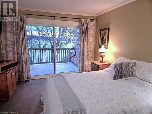 Primary bedroom featuring access to outside and crown molding - 555 Main Street S Unit# 5, Callander, ON - Indoor Photo Showing Bedroom