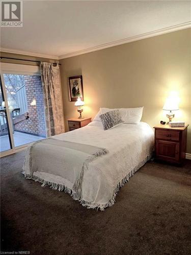 Primary Bedroom with carpet flooring, access to exterior, and ornamental molding - 555 Main Street S Unit# 5, Callander, ON - Indoor Photo Showing Bedroom