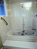 Bathroom featuring shower & jet-tub combination and heated floors - 