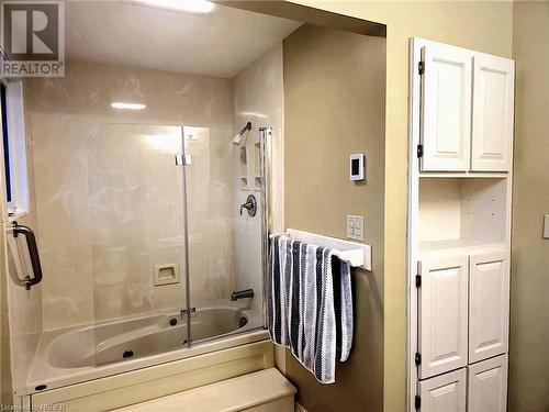 Primary Bathroom with combined bath / shower with glass door and heated floors - 555 Main Street S Unit# 5, Callander, ON - Indoor Photo Showing Bathroom