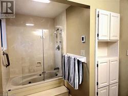 Primary Bathroom with combined bath / shower with glass door and heated floors - 