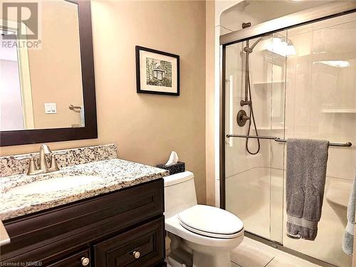 Bathroom featuring tile patterned floors, vanity, toilet, and walk in shower - 555 Main Street S Unit# 5, Callander, ON - Indoor Photo Showing Bathroom