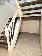 Stairway with carpet floors and wood walls - 