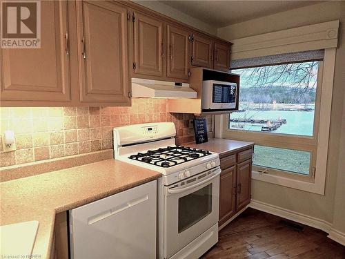 Kitchen featuring water views and a gas stove - 555 Main Street S Unit# 5, Callander, ON - Indoor Photo Showing Kitchen