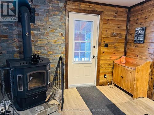 52 Doyon Street, Fauquier-Strickland, ON - Indoor Photo Showing Other Room With Fireplace