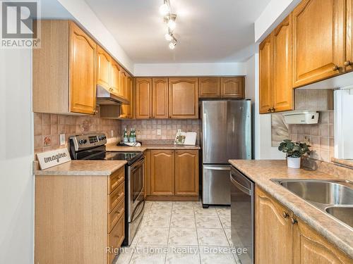 209 - 2301 Parkhaven Boulevard, Oakville (Uptown Core), ON - Indoor Photo Showing Kitchen With Stainless Steel Kitchen With Double Sink