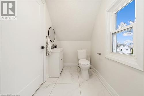 Bathroom featuring toilet, vanity, vaulted ceiling, and plenty of natural light - 45 Munroe Street, Hamilton, ON - Indoor Photo Showing Bathroom