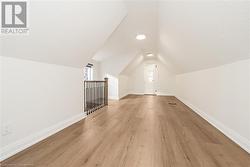 Bonus room featuring light wood-type flooring and lofted ceiling - 