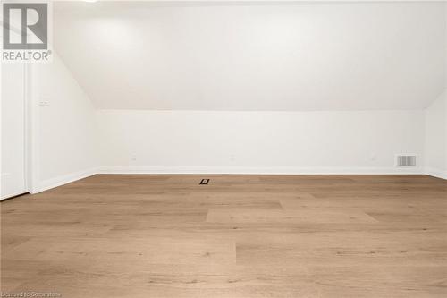 Additional living space featuring light hardwood / wood-style floors and lofted ceiling - 45 Munroe Street, Hamilton, ON - Indoor Photo Showing Other Room