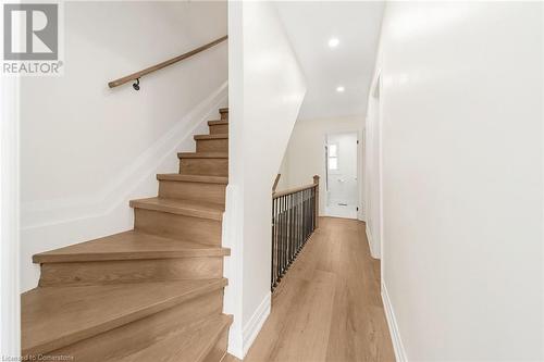 Stairs with hardwood / wood-style flooring - 45 Munroe Street, Hamilton, ON - Indoor Photo Showing Other Room