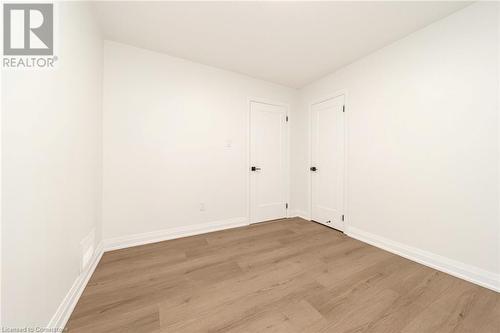 Unfurnished room with light hardwood / wood-style floors - 45 Munroe Street, Hamilton, ON - Indoor Photo Showing Other Room