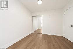 Unfurnished bedroom with light hardwood / wood-style flooring and a closet - 