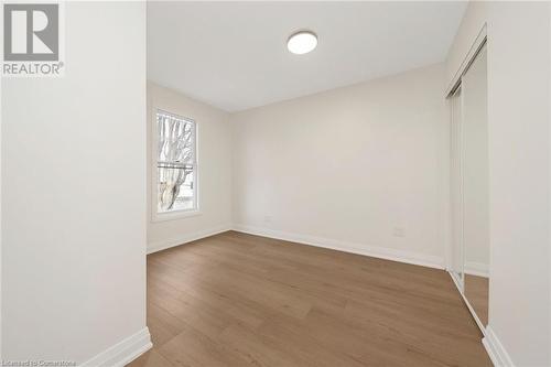 Spare room featuring wood-type flooring - 45 Munroe Street, Hamilton, ON - Indoor Photo Showing Other Room