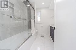 Full bathroom featuring vanity, bath / shower combo with glass door, and toilet - 