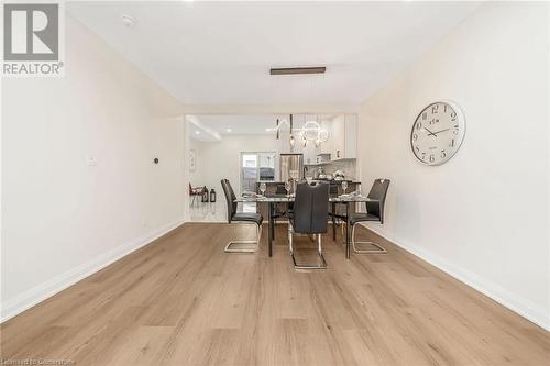 Dining area featuring a chandelier and light hardwood / wood-style floors - 45 Munroe Street, Hamilton, ON - Indoor Photo Showing Dining Room